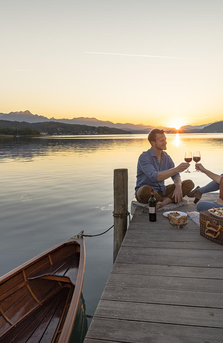 Paerchen beim Picknick am Steg in Poertschach am Woerthersee