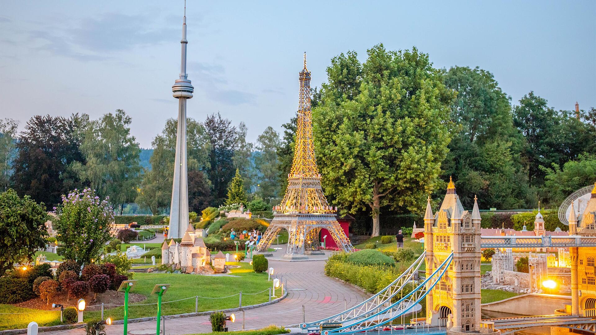 Minimundus - Die kleine Welt am Wörthersee Modellnachbauten von Eiffelturm, Tower Bridge und CN Tower im Minimundus Klagenfurt, umgeben von Grünanlagen und Spazierwegen.